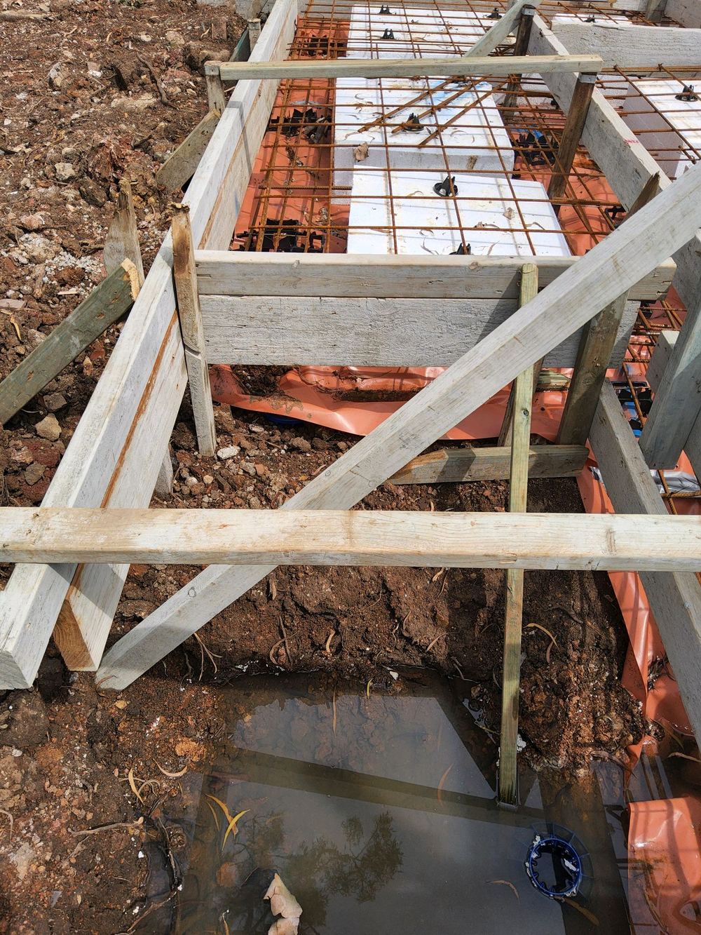 Stepped strip footing at risk of blowout without secured formwork, found during a slab pre-pour inspection in Pennant Hills